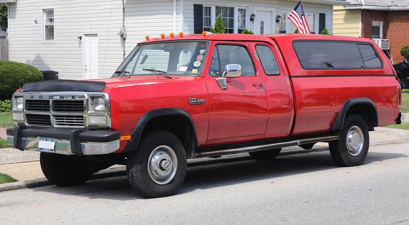 Red 1993 Dodge Ram W250 Club Cab 4x4 Cummins turbodiesel with a bed cap